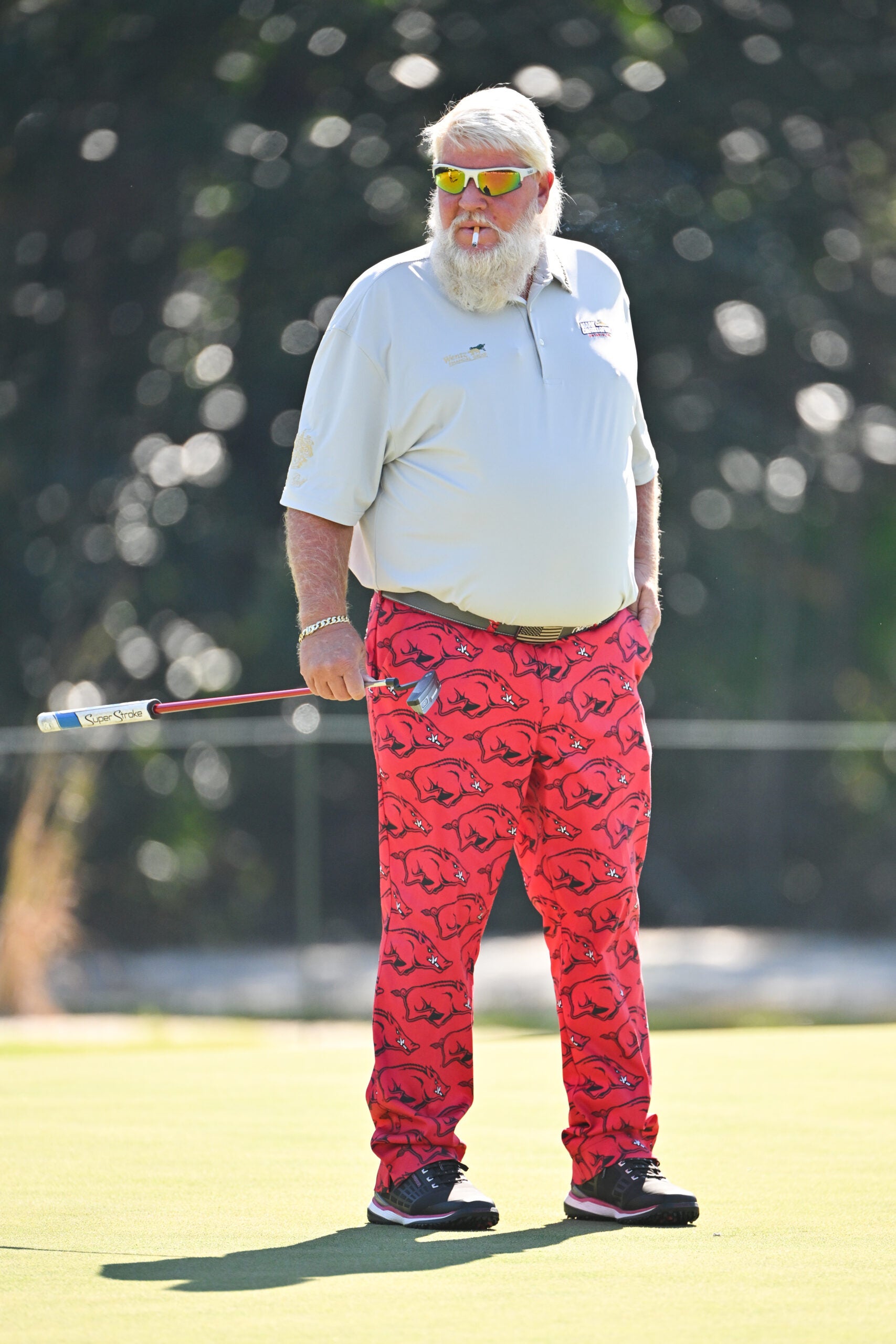 PONTE VEDRA BEACH, FLORIDA - OCTOBER 08: John Daly smokes a cigarette while playing the first green during the second round of the PGA TOUR Champions Constellation FURYK & FRIENDS presented by Circle K at Timuquana Country Club on October 8, 2022 in Jacksonville, Florida. (Photo by Ben Jared/PGA TOUR via Getty Images)