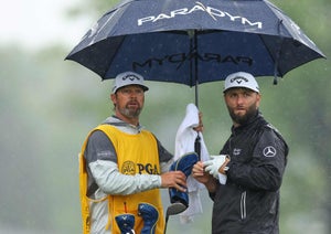 on Rahm of Spain speaks with caddie Adam Hayes on the eighth tee during the third round of the 2023 PGA Championship at Oak Hill Country Club on May 20, 2023 in Rochester, New York.
