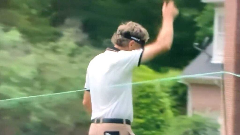 Bernhard Langer javelin-throws putter and tosses ball into woods. (Yes, Langer)