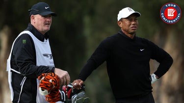Tiger Woods of the United States and his caddie Joe Lacava wait to play a shot on the 17th hole during the second round of the The Genesis Invitational at Riviera Country Club on February 17, 2023 in Pacific Palisades, California.