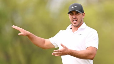 Brooks Koepka of the United States gestures as he walks off the ninth tee during a practice round prior to the 2023 PGA Championship at Oak Hill Country Club on May 16, 2023 in Rochester, New York