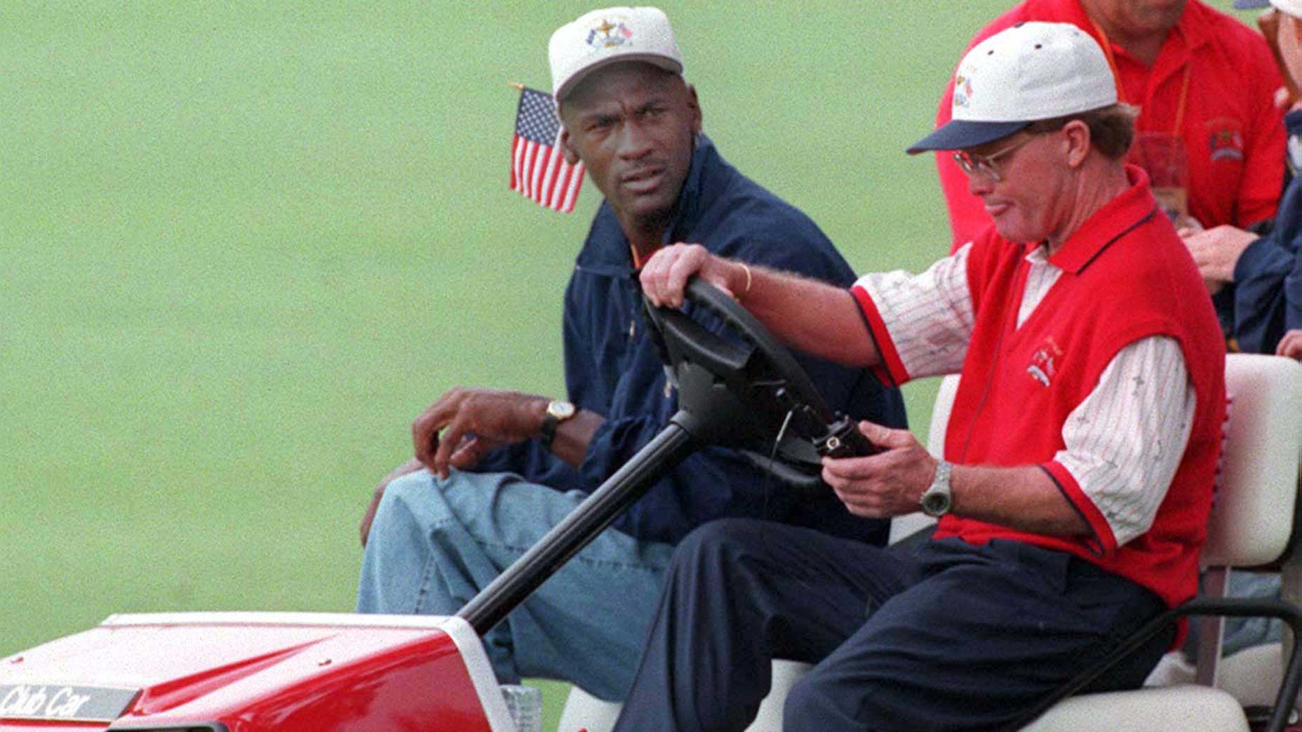 American Ryder Cup team Captain Tom Kite offers a lift to US Basket Ball player Michael Jordan (back, right). Jordan was following the fortunes of USA player Tiger Woods throughout the fourball match against Europe at Valderrama in Spain today (Saturday).