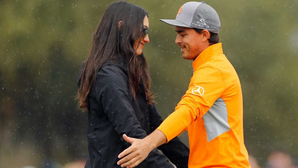 Rickie Fowler is met and congratulated by his fiancé Allison Stokke on the 18th green after winning the Waste Management Phoenix Open at TPC Scottsdale on February 03, 2019 in Scottsdale, Arizona.