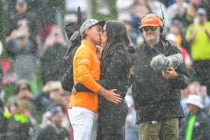 Rickie Fowler and his fiancee Allison Stokke kiss on the eighteenth hole green after the final round of the Waste Management Phoenix Open at TPC Scottsdale on February 3, 2019 in Scottsdale, Arizona.