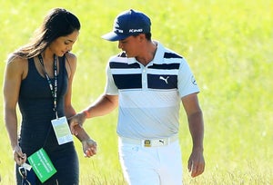 Rickie Fowler of the United States walks along the course with Allison Stokke during a practice round prior to the 2017 U.S. Open at Erin Hills on June 14, 2017 in Hartford, Wisconsin.