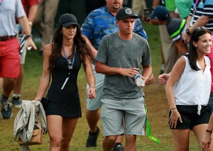 Rickie Fowler of the United States and Allison Stokke walk along the on the 18th green during the final round of the 2017 PGA Championship at Quail Hollow Club on August 13, 2017 in Charlotte, North Carolina.