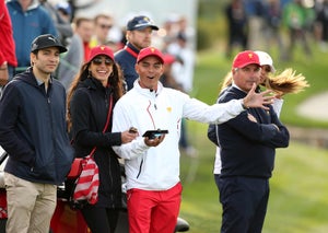 Rickie Fowler of the U.S. Team and girlfriend Allison Stokke watch the action during the afternoon four-ball matches at the Presidents Cup at Liberty National Golf Club on September 30, 2017, in Jersey City, New Jersey.