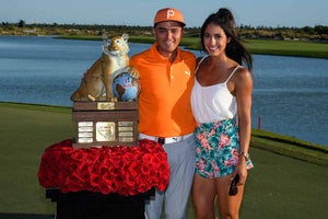 Rickie Fowler and his girlfriend Allison Stokke poses with the trophy during the final round of the Hero World Challenge at Albany course on December 3, 2017 in Nassau, Bahamas.