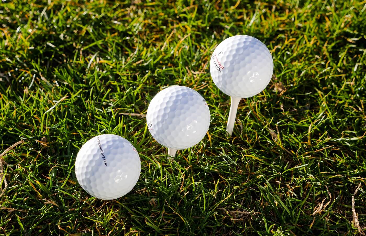best golf balls for slow swing speeds: three golf balls on tee