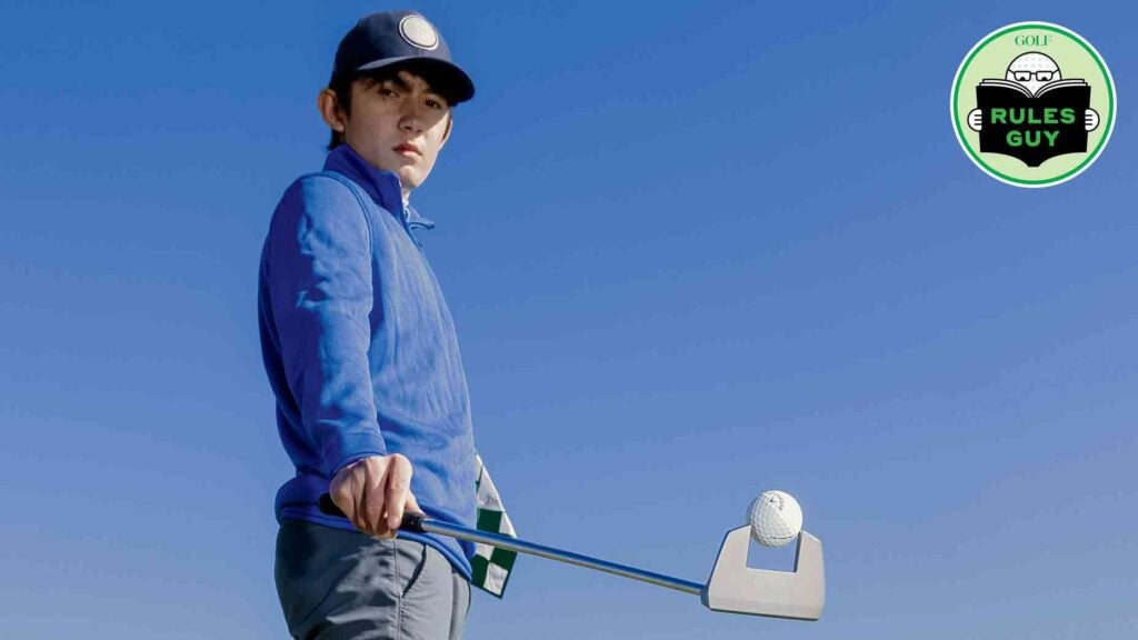 golfer holding ball in putter