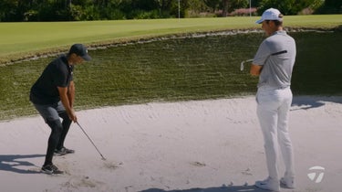 tiger woods playing a bunker shot