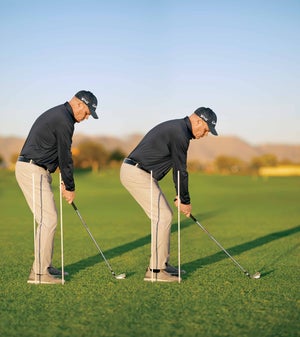 man stands over ball