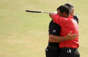 Tiger Woods of the United States (R) hugs his caddy Steve Williams after winning the 135th British Open Golf Championships in Hoylake, in Liverpool, in north-west England, 23 July 2006.