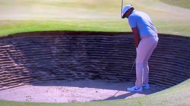 Tony Finau putting backwards in a greenside bunker.