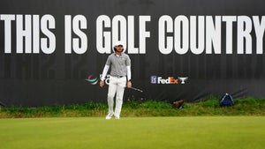 tommy fleetwood walks golf country sign