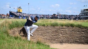 Jordan Spieth plays from the bunker on the 18th hole during the first day of the Open Championship at Royal Liverpool in Hoylake, England.