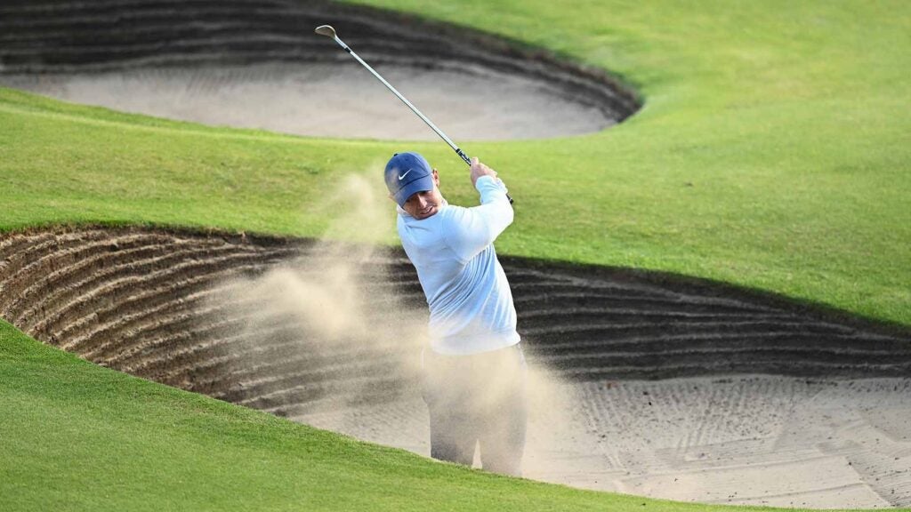 rory mcilroy blasts out of a pot bunker
