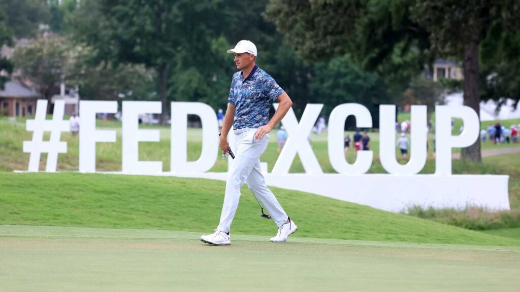 Jordan Spieth walks in front of FedEx Cup signage during the third round of the FedEx St. Jude Championship on August 12, 2023 at TPC Southwind in Memphis, Tennessee.