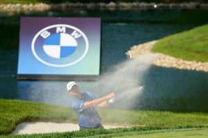 Justin Rose of England plays a shot from the bunker on the 18th hole during the third round of the BMW Championship at Olympia Fields Country Club on August 19, 2023 in Olympia Fields, Illinois.