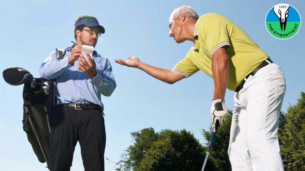 golfer pointing his arm at caddie
