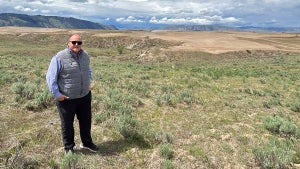 Gamble Sands GM Blake Froling, with the 16th hole of the new DMK course at Gamble Sands behind him.