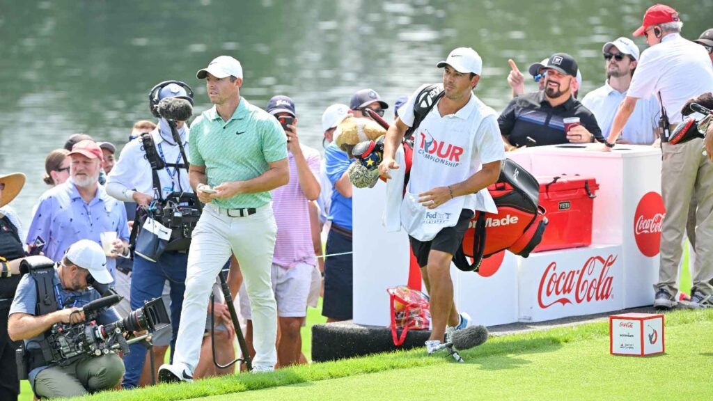 Rory McIlroy and caddie walk off tee at Tour Championship