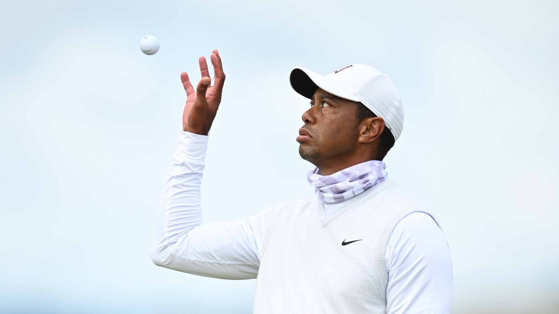 tiger woods holds golf ball