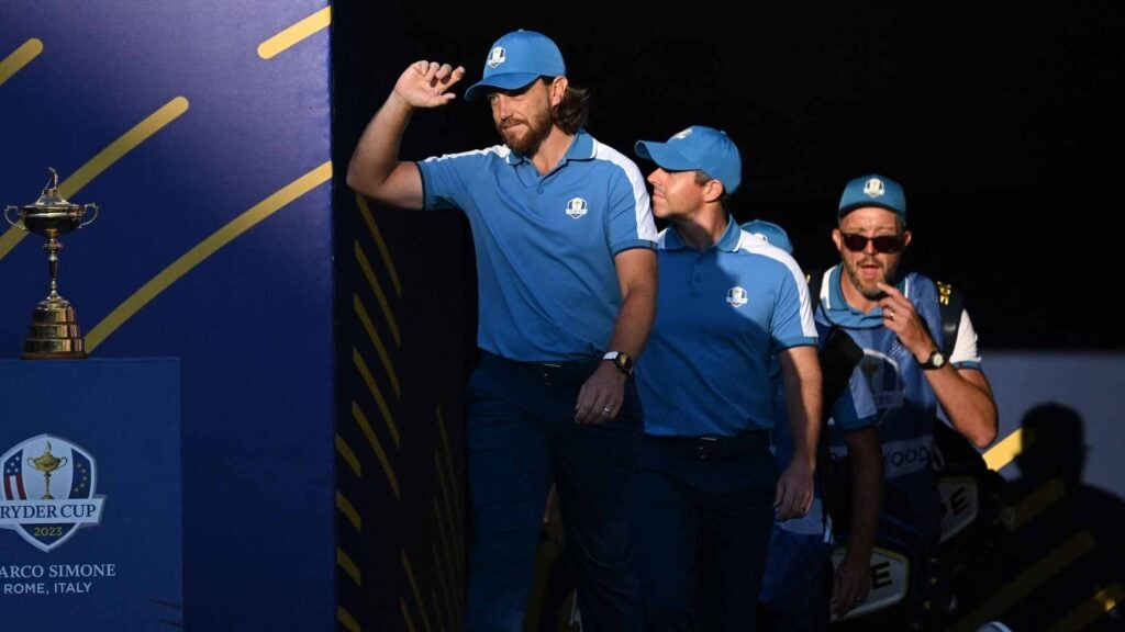 Tommy Fleetwood and Rory McIlroy walk onto the first tee at Marco Simone.