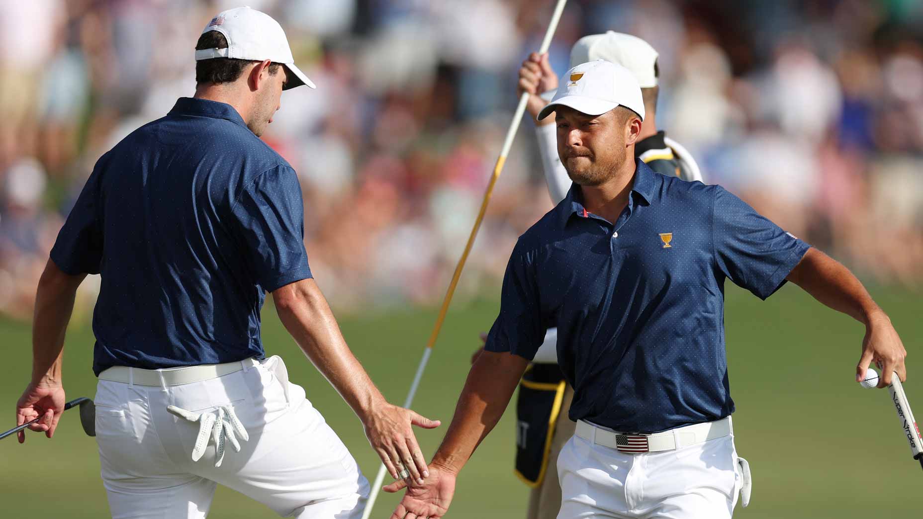 Xander Schauffele (R) of the United States Team celebrates making his putt on the 15th green with teammate Patrick Cantlay (L) during Saturday afternoon four-ball matches on day three of the 2022 Presidents Cup at Quail Hollow Country Club on September 24, 2022 in Charlotte, North Carolina.