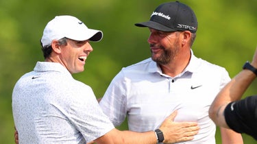 Michael Block (R) of the United States, PGA of America Club Professional, celebrates his hole-in-one on the 15th tee with Rory McIlroy (L) of Northern Ireland during the final round of the 2023 PGA Championship at Oak Hill Country Club on May 21, 2023 in Rochester, New York.