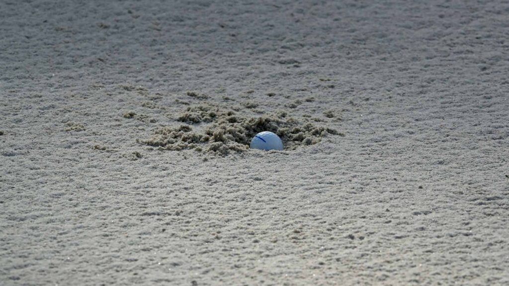 golf ball buried in the bunker