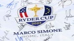 A fan holds an autographed flag the the 2023 Ryder Cup.