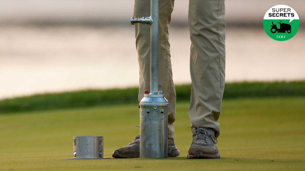 superintendent cutting golf hole