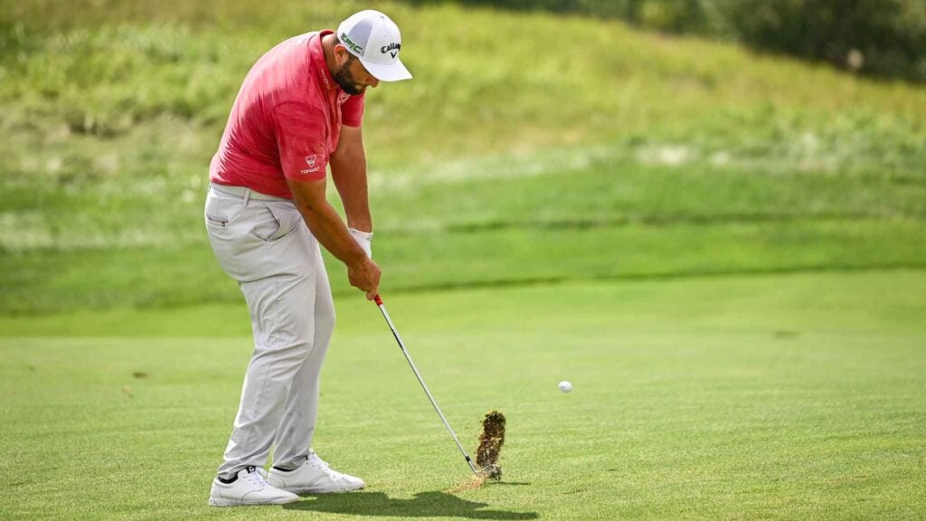 Jon Rahm take a divot