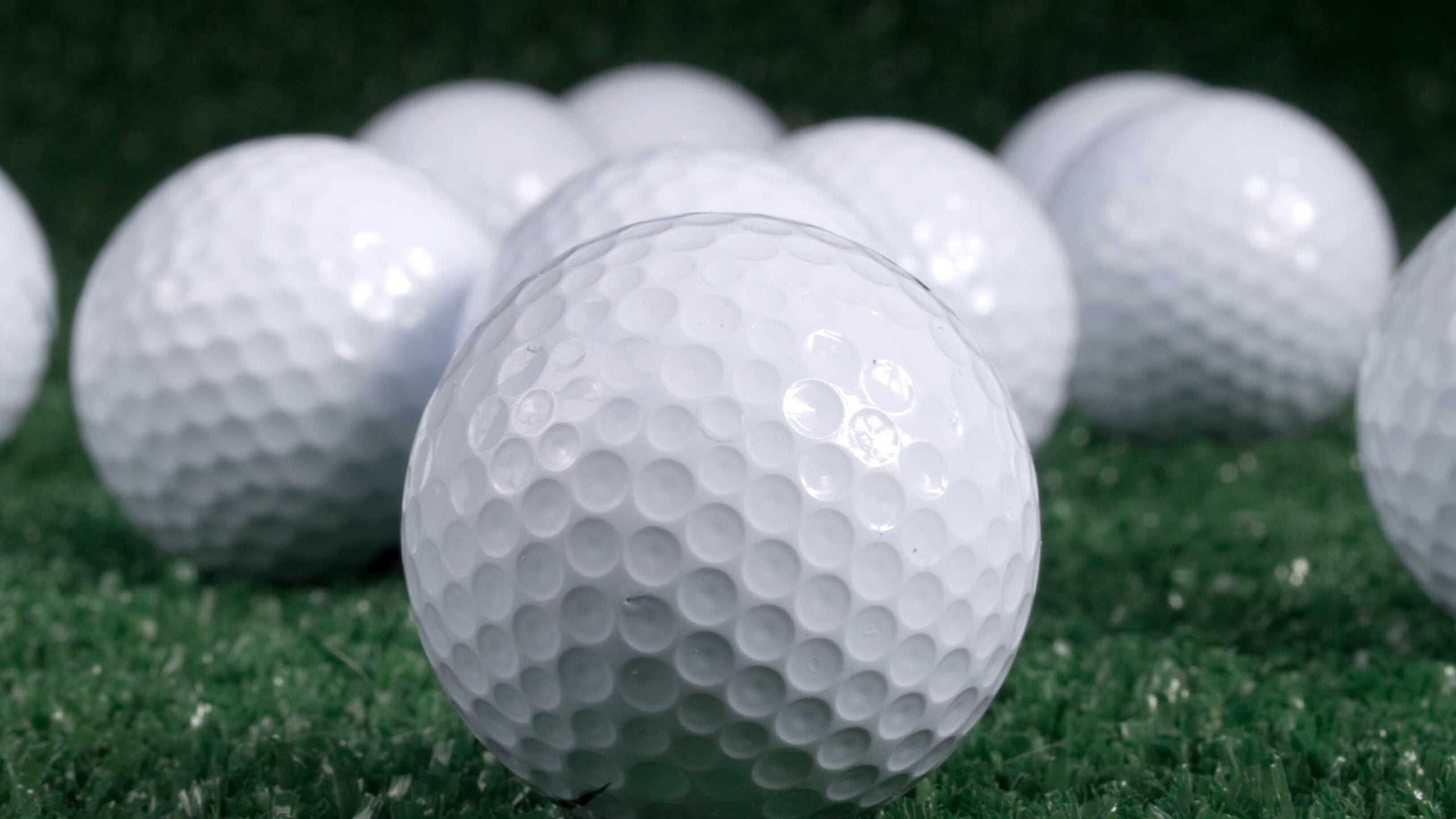 several golf balls on turf