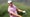 Rasmus Hojgaard, a golfer in a pink shirt, swinging a golf club.