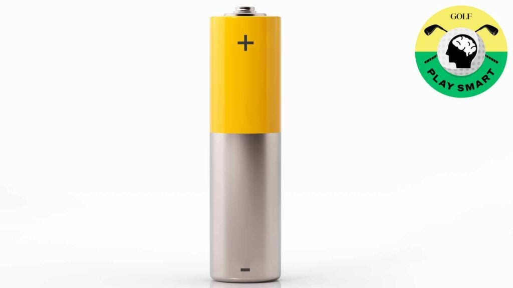 a yellow and silver aa battery sits straight up on a white background
