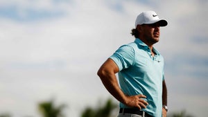 brooks koepka holds hips in blue shirt at LIV Golf team championships in Miami