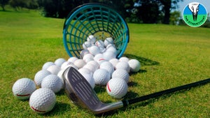 Golf balls pouring out of basket onto grass