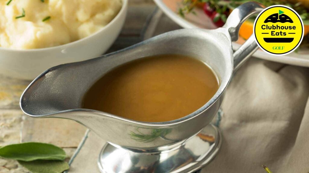 A gravy boat filled with gravy on a dinner table