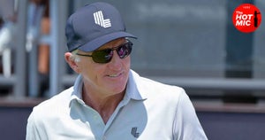 greg norman smiles in navy liv hat, gray liv polo shirt and aviator sunglasses at LIV Jeddah