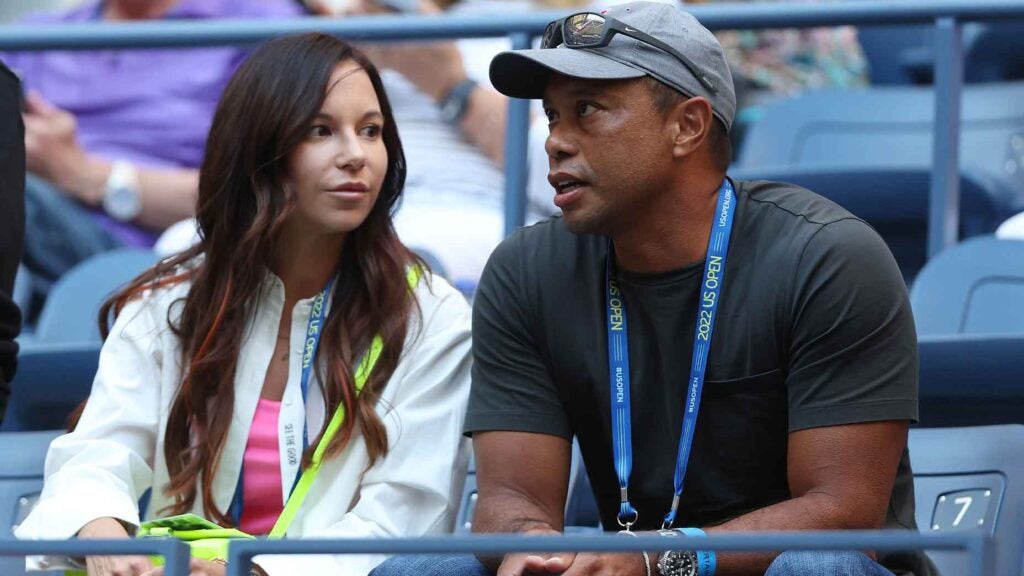 erica herman and tiger woods look on from the stands at the u.s. open in Queens, New York.