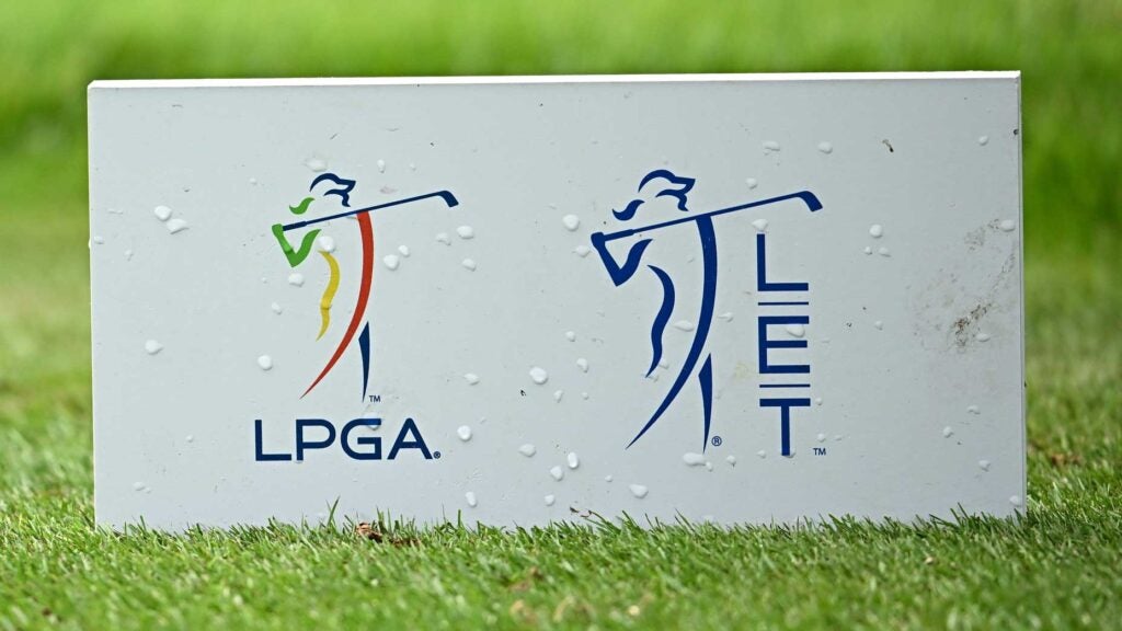 A tee marker with the LPGA and LET logos on a golf tee
