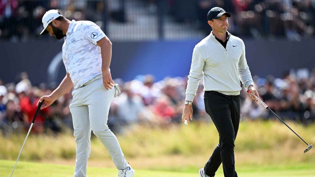 rory mcilroy walks next to jon rahm at the open championship in England.