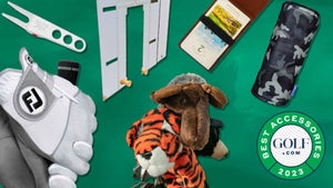 A collection of golf accessories on a green background