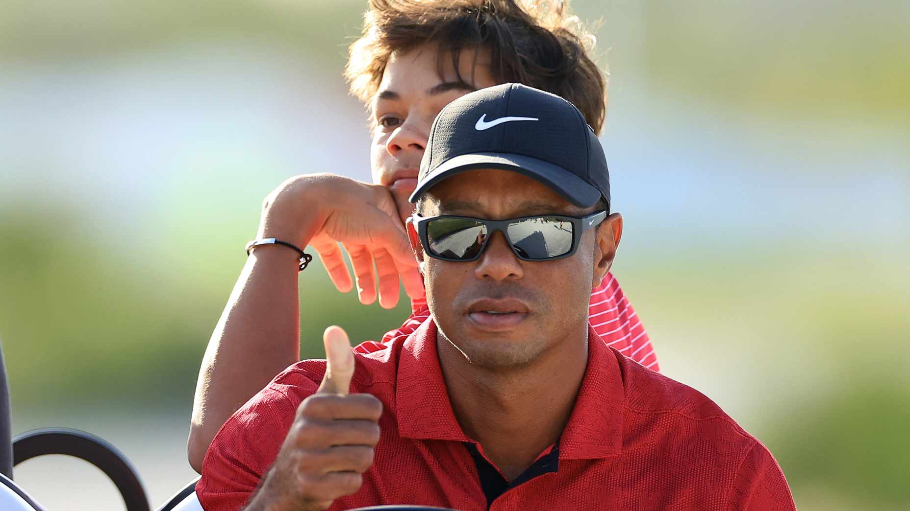 Tiger Woods watches Hero World Challenge in golf cart with son Charlie Woods
