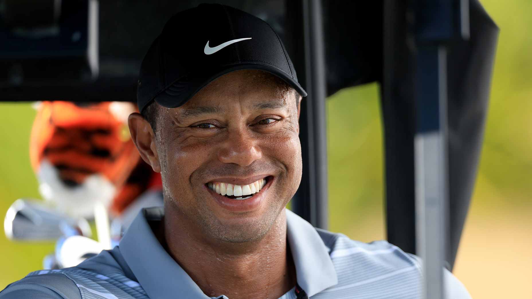 Tiger Woods smiles in golf cart at 2023 Hero World Challenge
