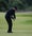 tiger woods swings with an iron in the fairway during the 2002 open championship