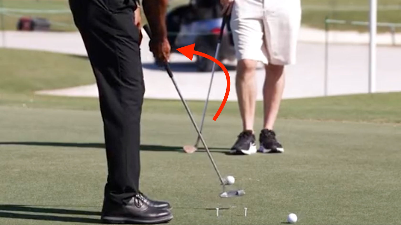Tiger woods working on one-handed putting drill at hero world challenge