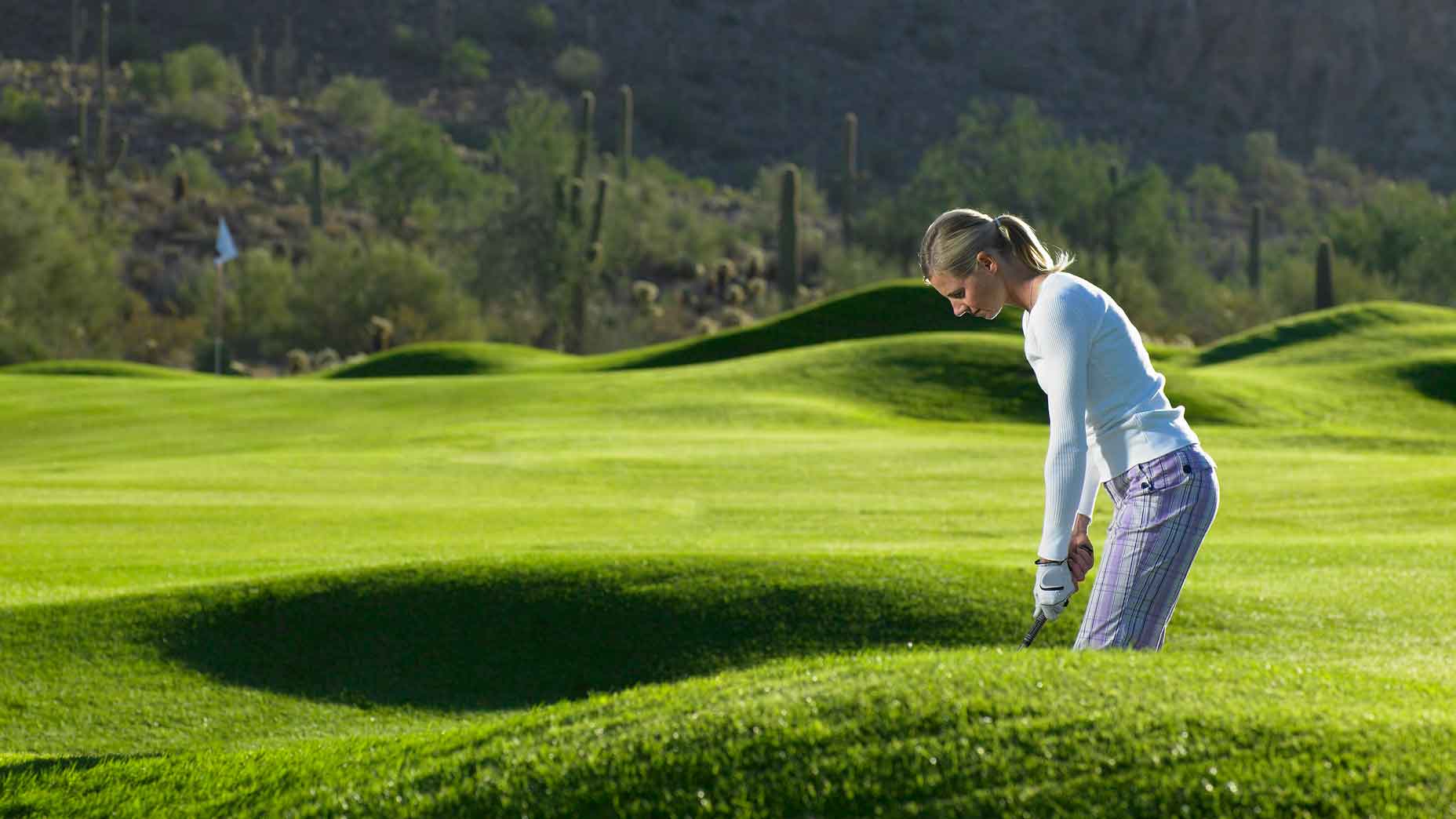 A woman hits a golf shot in Arizona, Gold Canyon Golf Resort